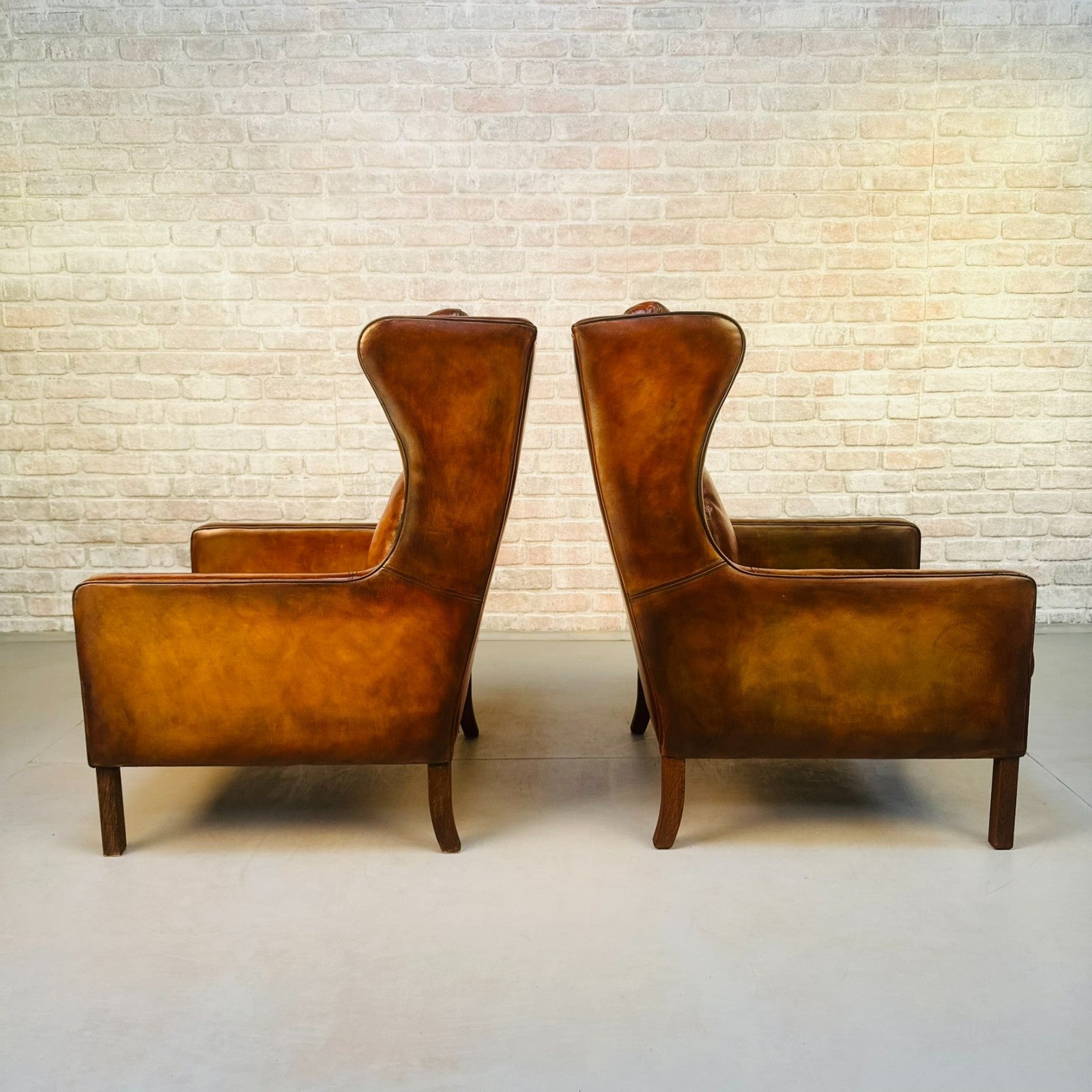 Pair Vintage Danish Wingback Chairs & Footstool Tan Leather Lounge Set