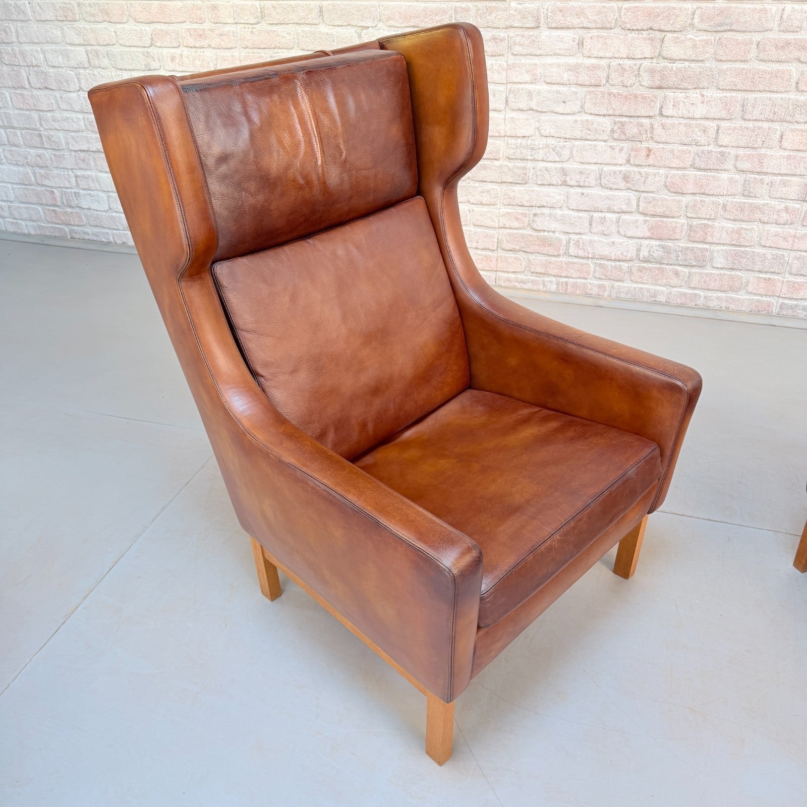 Vintage 1970s His & Hers Danish Tan Leather Armchairs Solid Oak Base Pair