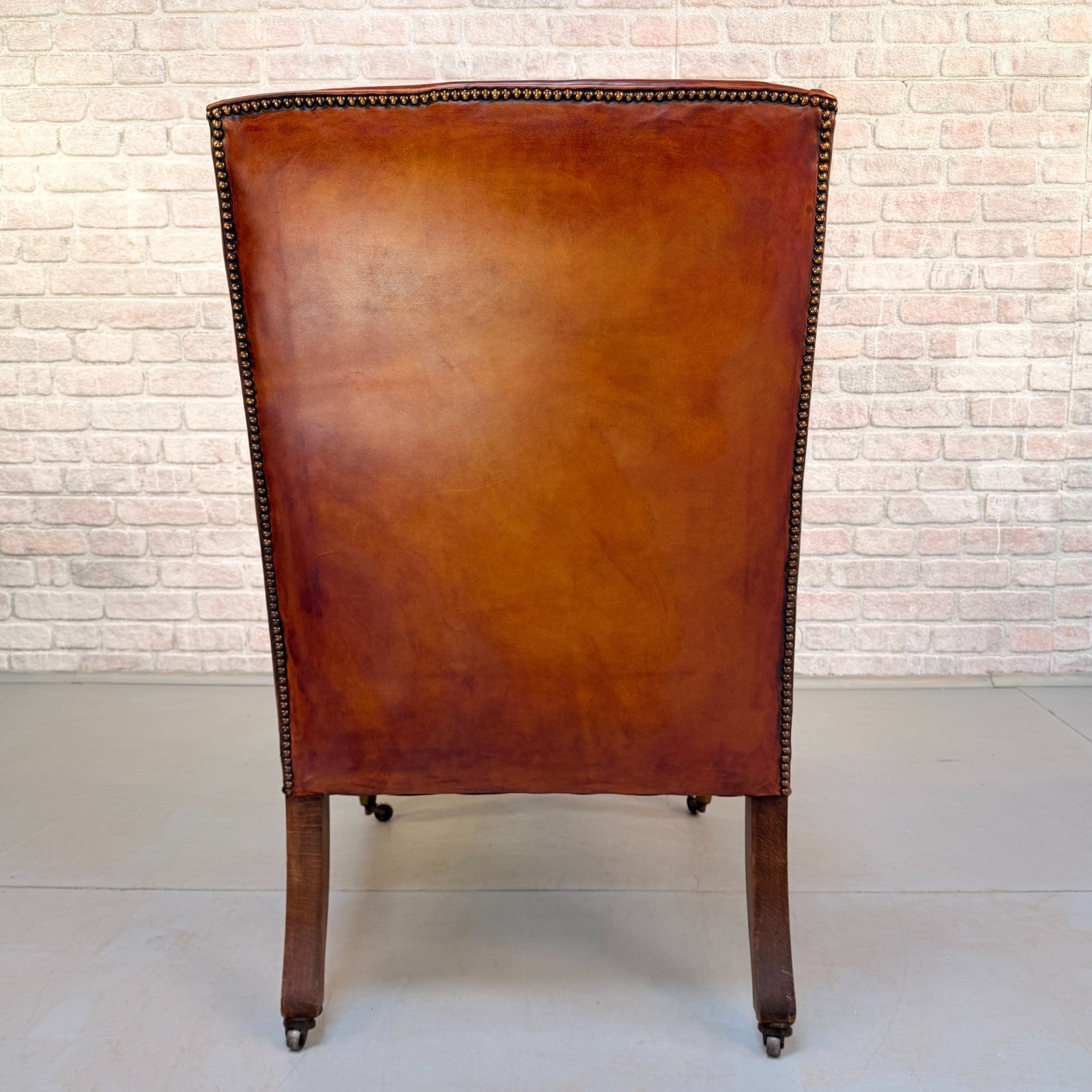 Circa 1910 Antique Tan Leather Armchair Hand Dyed Feather Cushions Castors