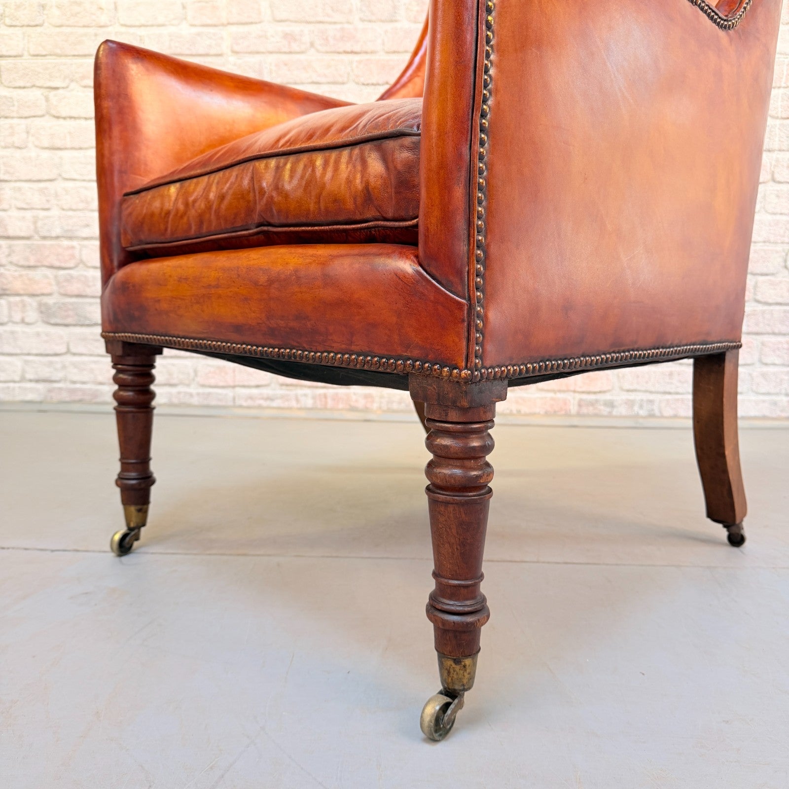 Circa 1910 Antique Tan Leather Armchair Hand Dyed Feather Cushions Castors