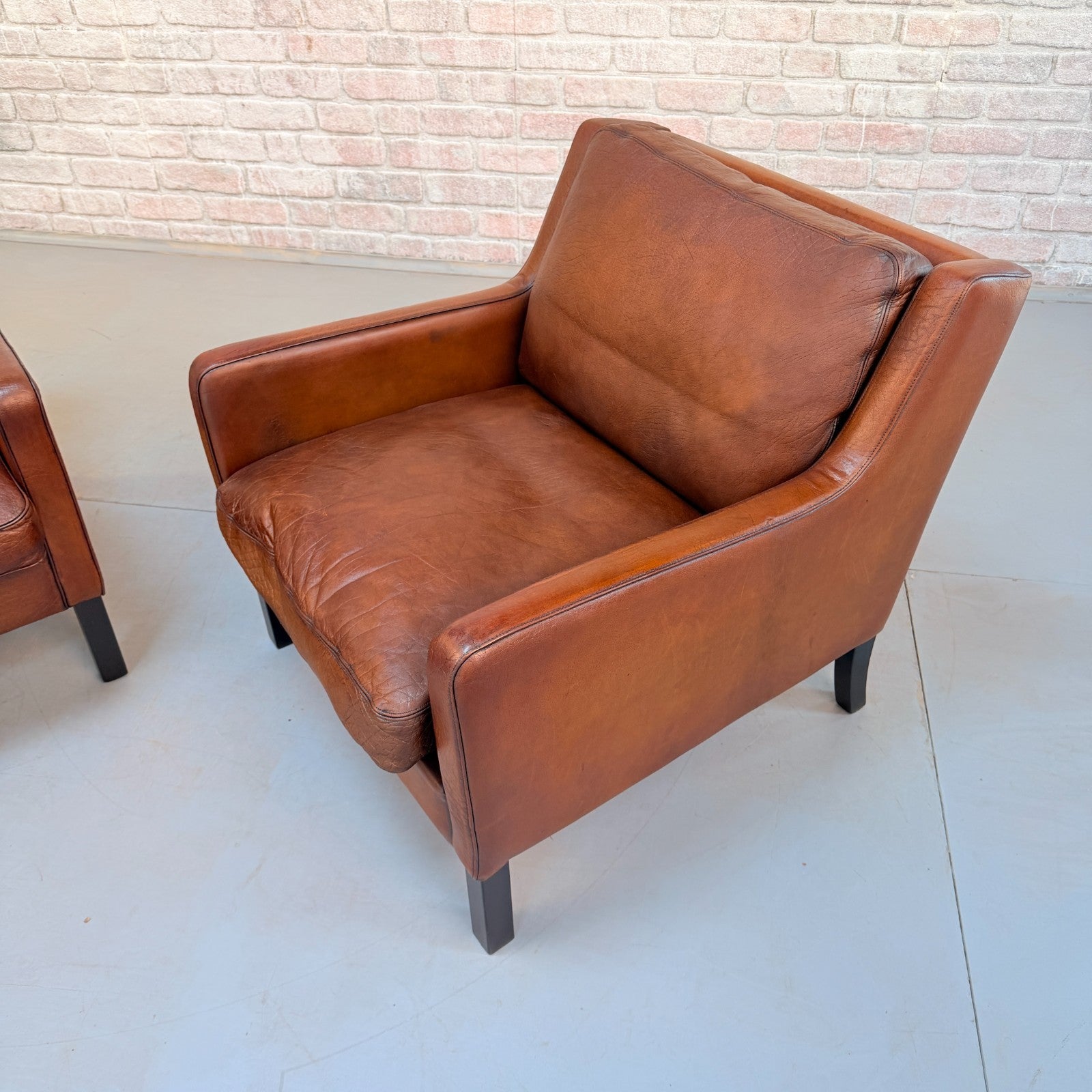 Vintage Near Pair Danish Tan Leather Armchairs Hand Dyed Feather Cushions