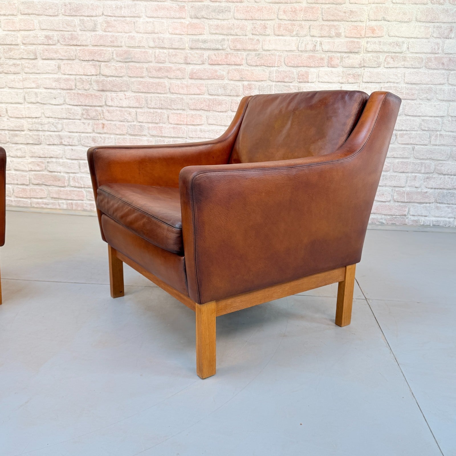 Vintage 1970s His & Hers Danish Tan Leather Armchairs Solid Oak Base Pair
