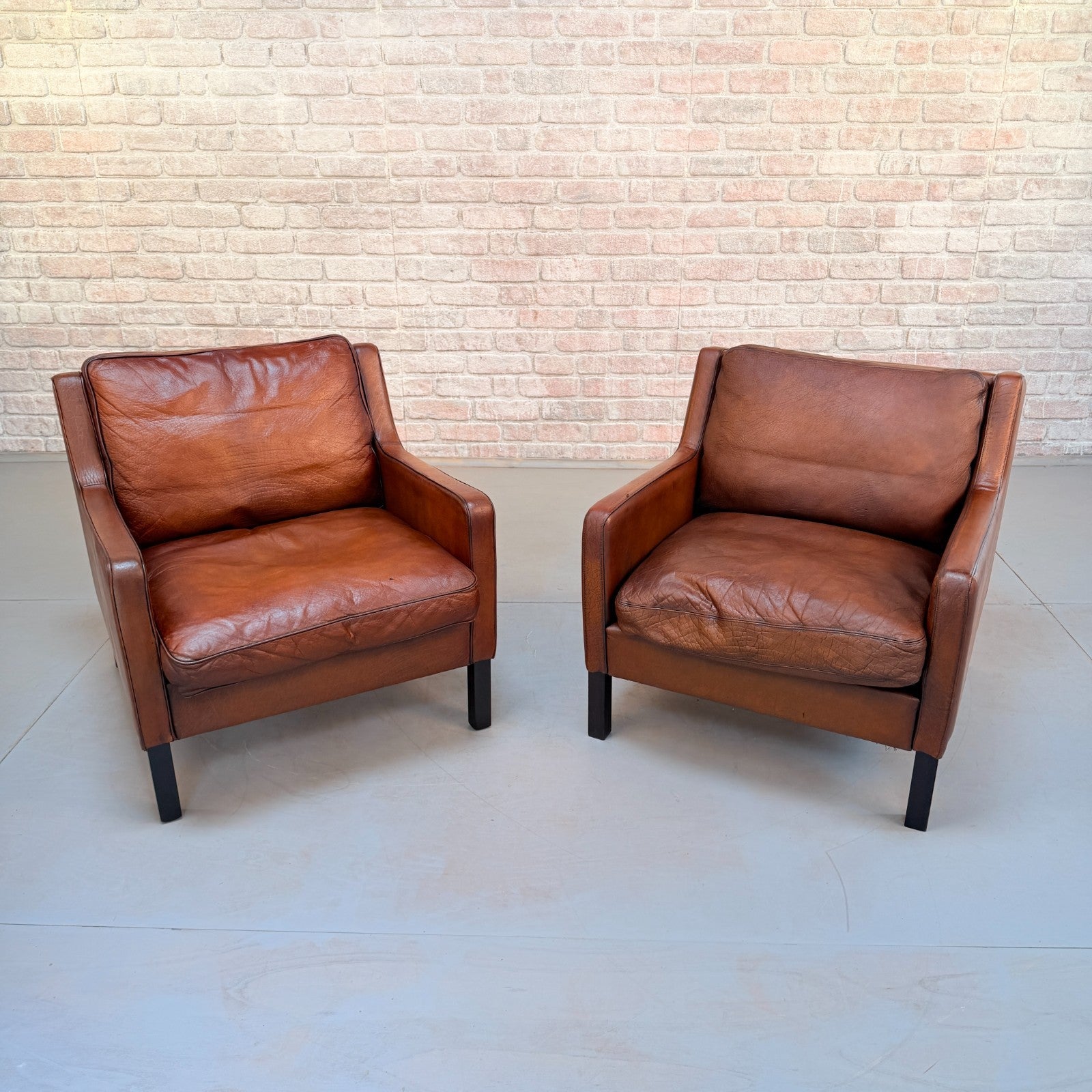 Vintage Near Pair Danish Tan Leather Armchairs Hand Dyed Feather Cushions
