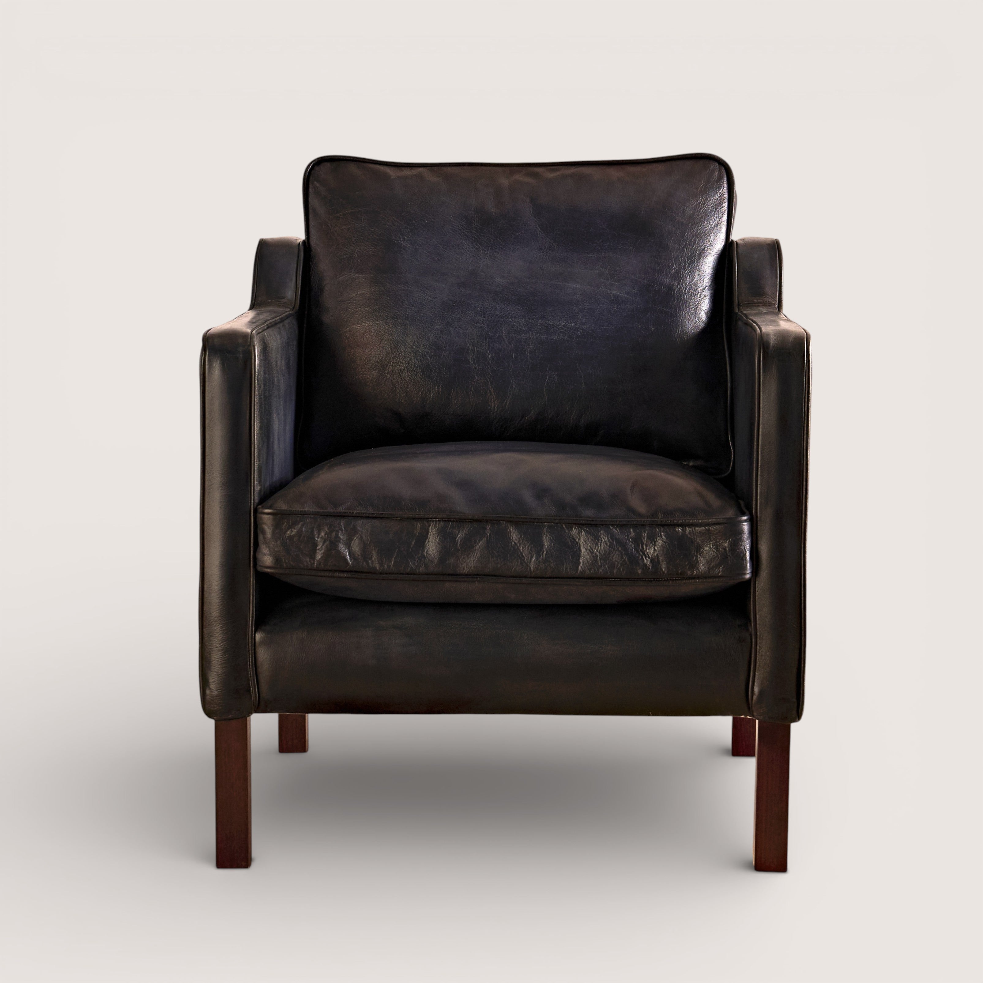 luxury-hand-dyed-mid-century-black-leather-armchair-white-background-front