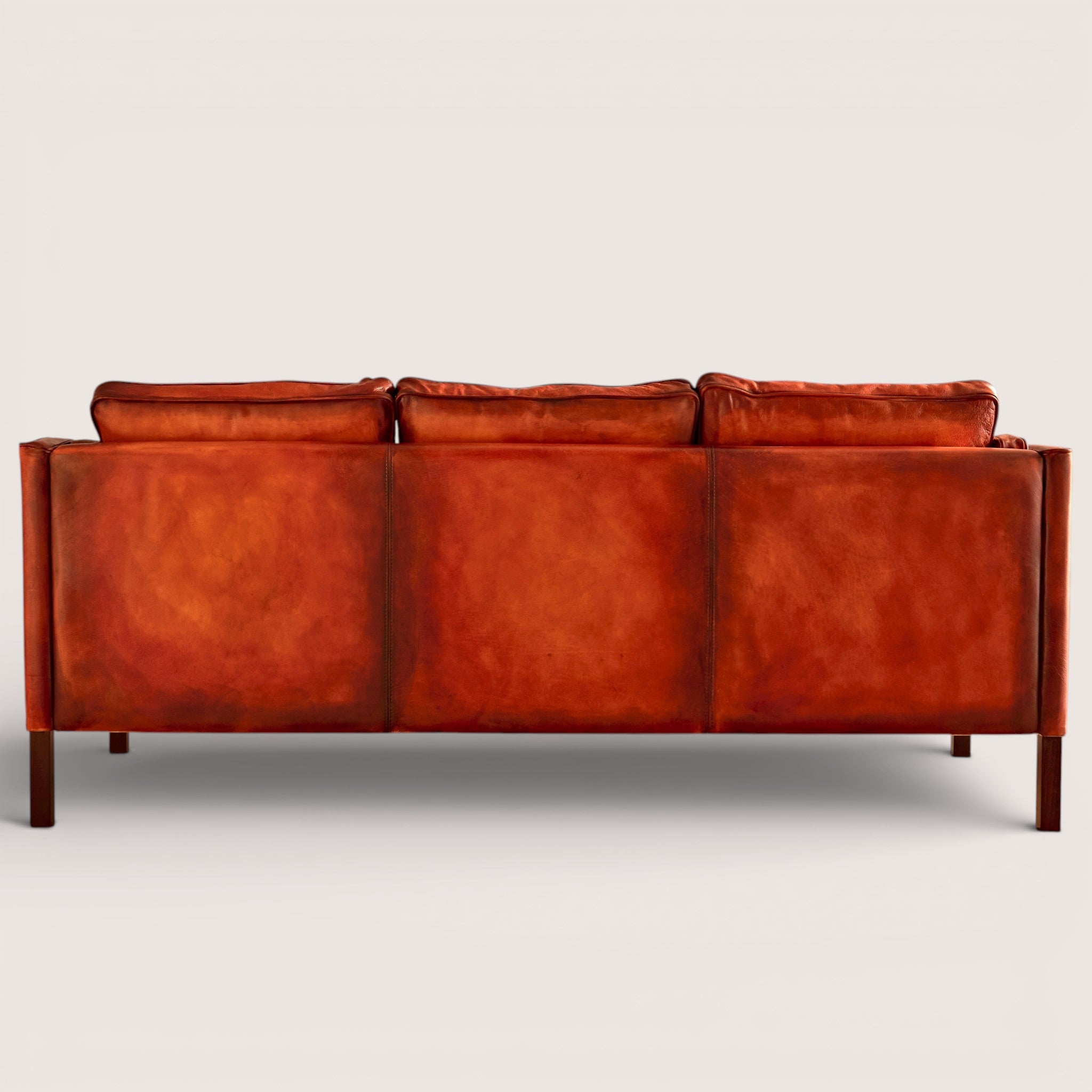luxury-hand-dyed-mid-century-cognac-tan-leather-three-seater-sofa-white-background-back