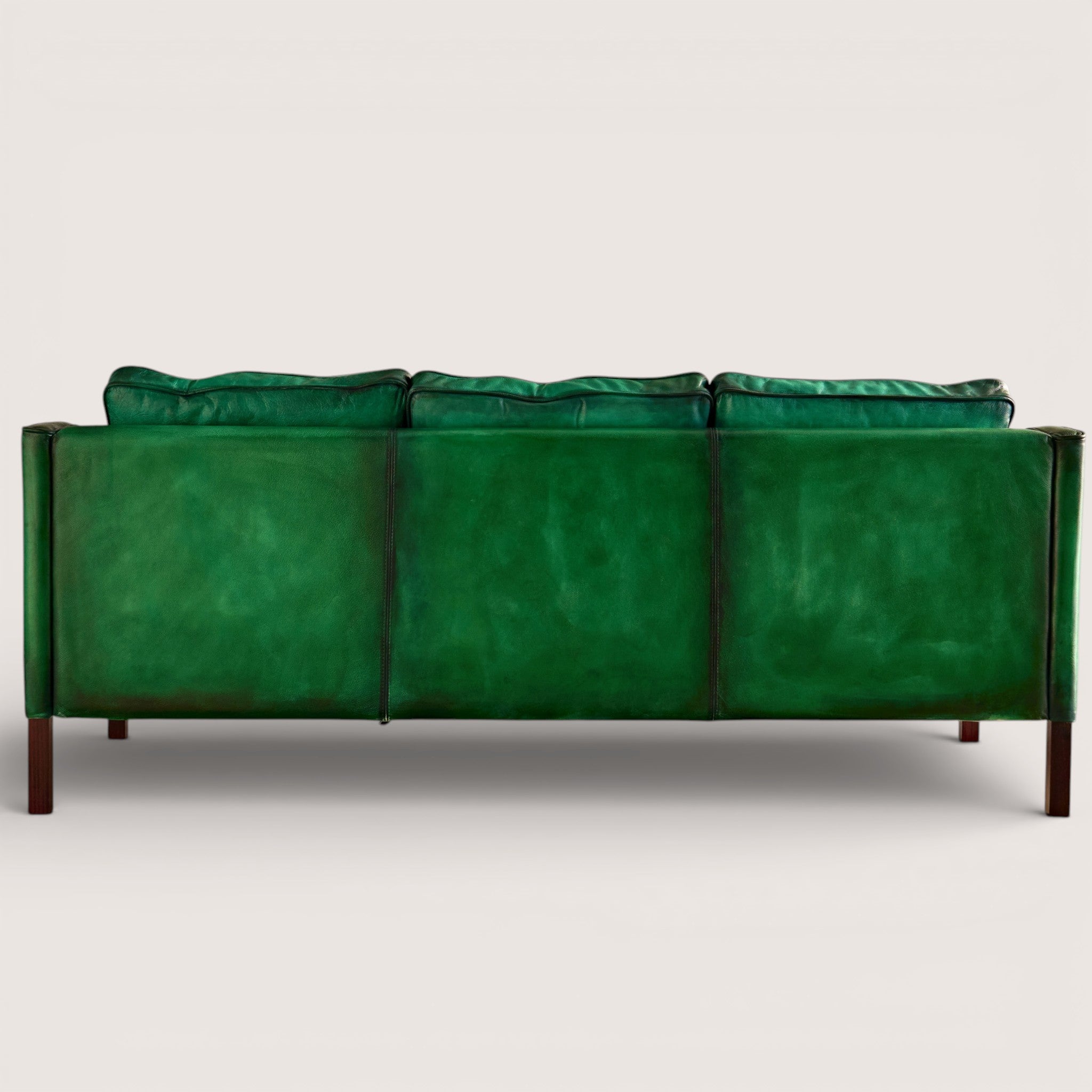luxury-hand-dyed-mid-century-green-leather-three-seater-sofa-white-background-back