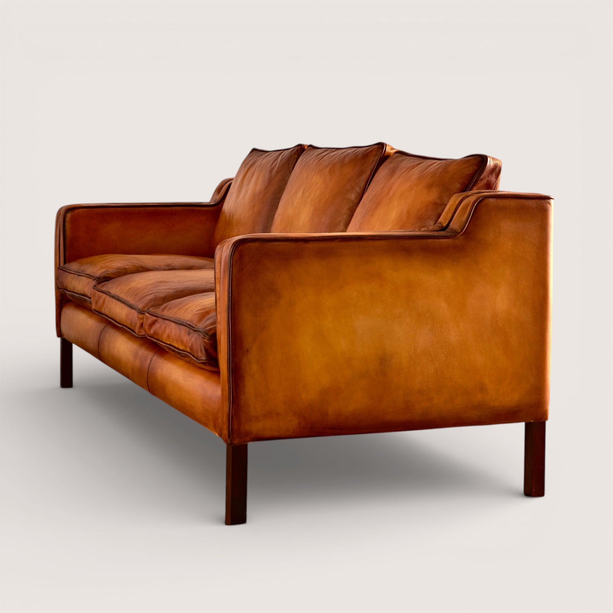 luxury-hand-dyed-mid-century-tan-leather-three-seater-sofa-white-background-side