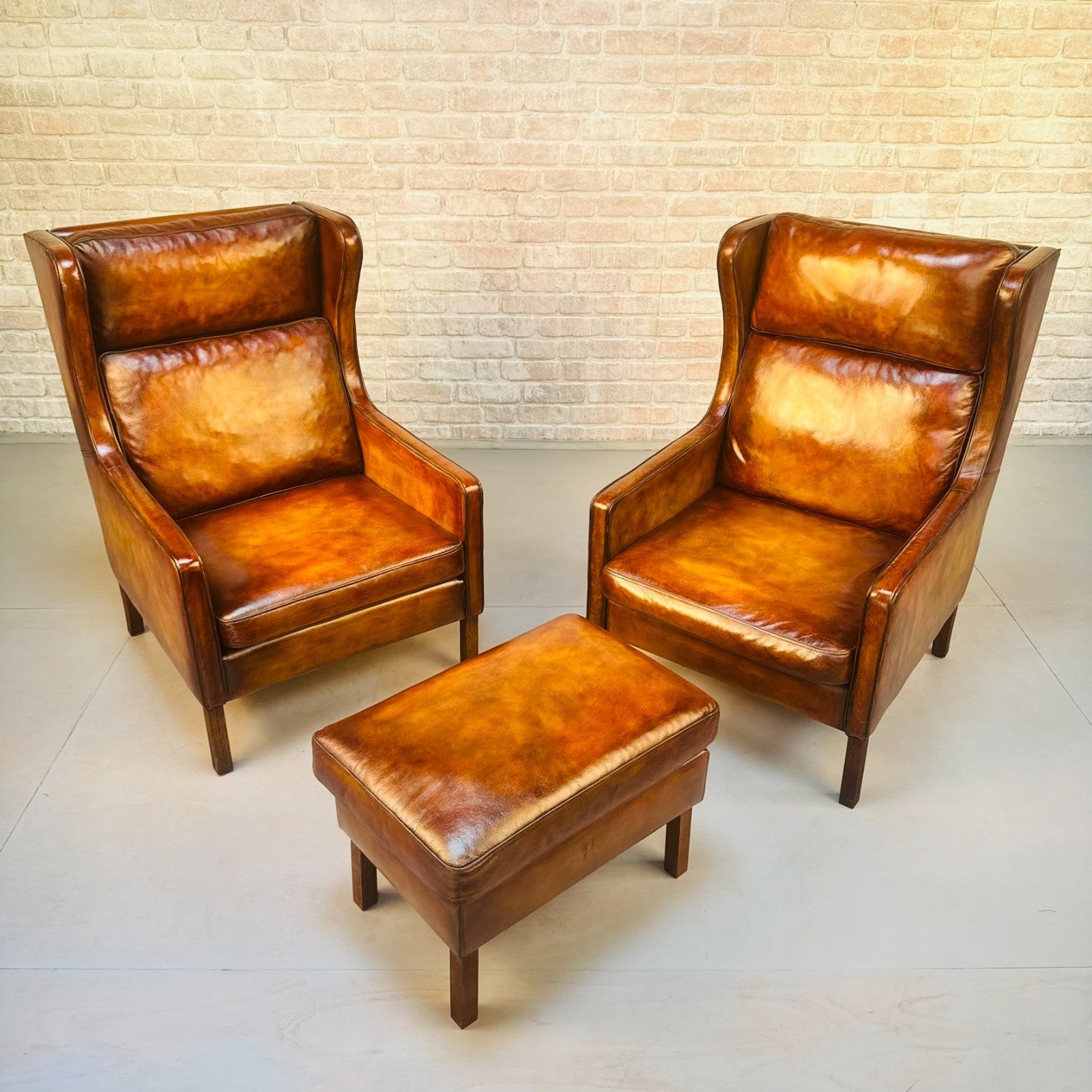 Pair Vintage Danish Wingback Chairs & Footstool Tan Leather Lounge Set