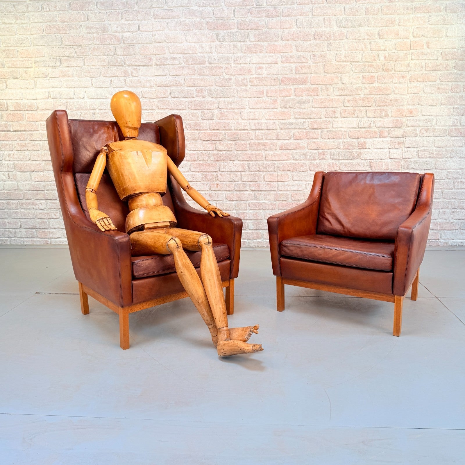 Vintage 1970s His & Hers Danish Tan Leather Armchairs Solid Oak Base Pair