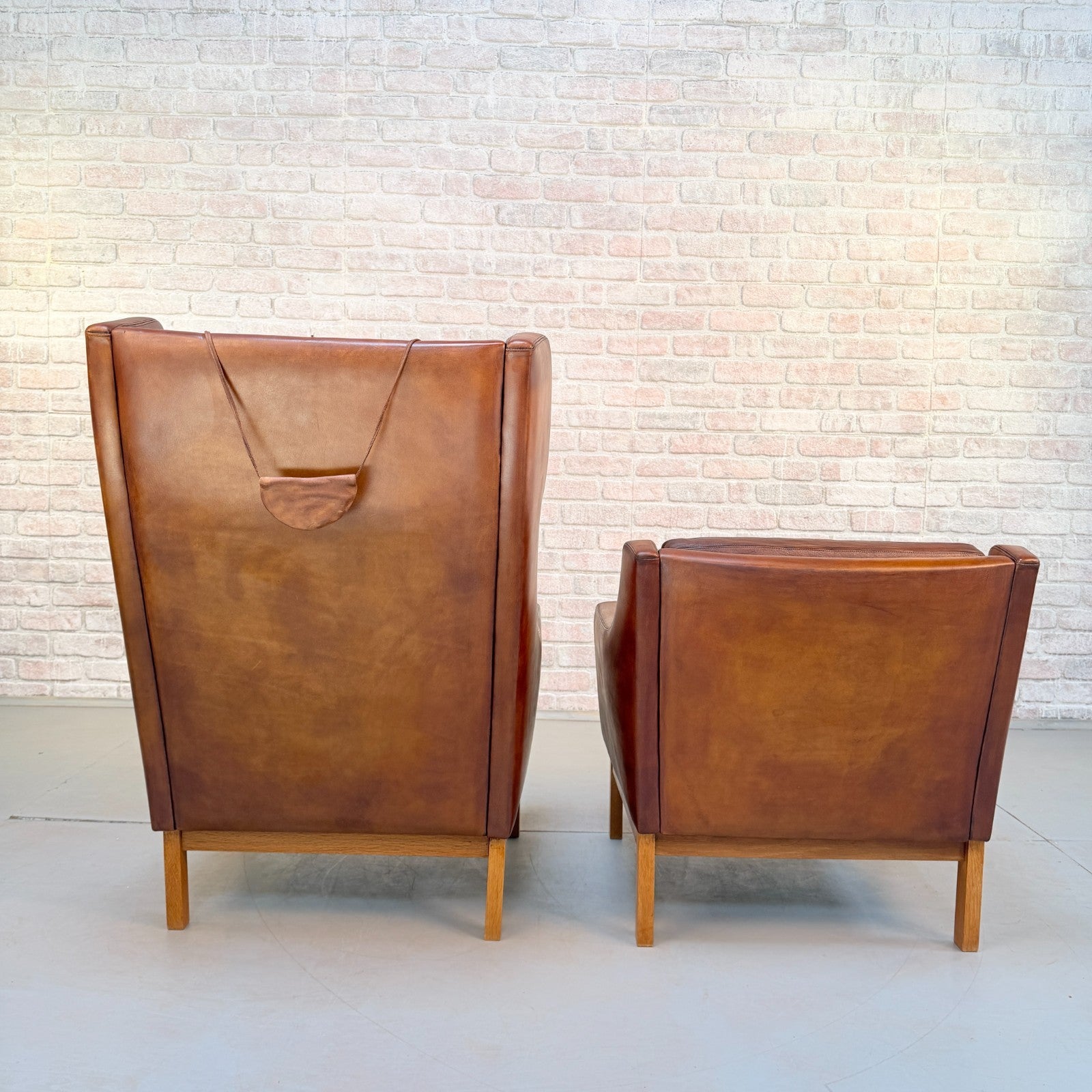 Vintage 1970s His & Hers Danish Tan Leather Armchairs Solid Oak Base Pair