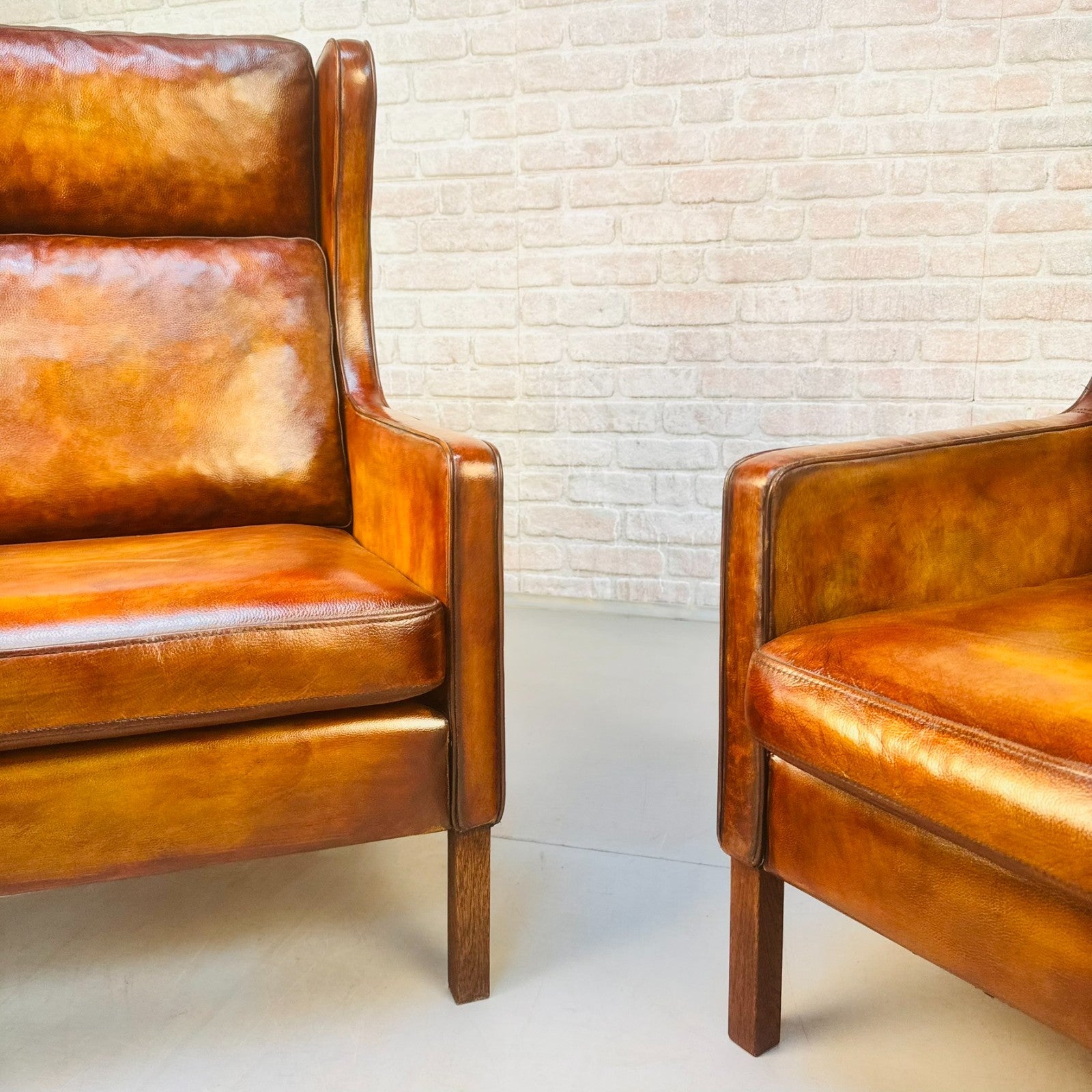 Pair Vintage Danish Wingback Chairs & Footstool Tan Leather Lounge Set