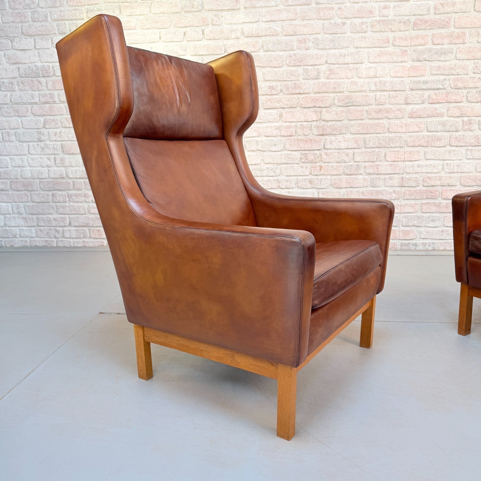 Vintage 1970s His & Hers Danish Tan Leather Armchairs Solid Oak Base Pair