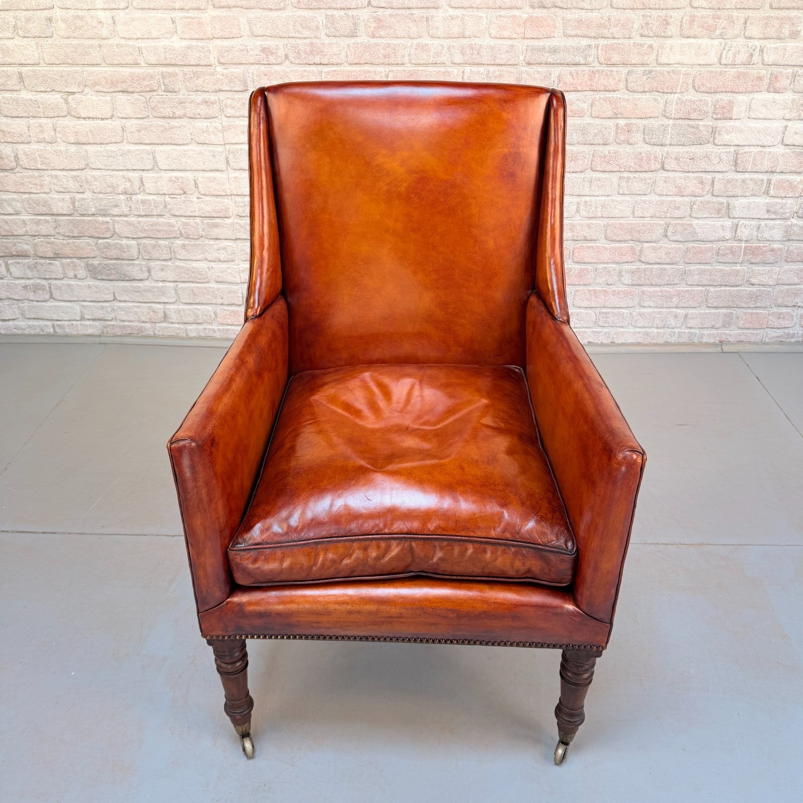 Circa 1910 Antique Tan Leather Armchair Hand Dyed Feather Cushions Castors