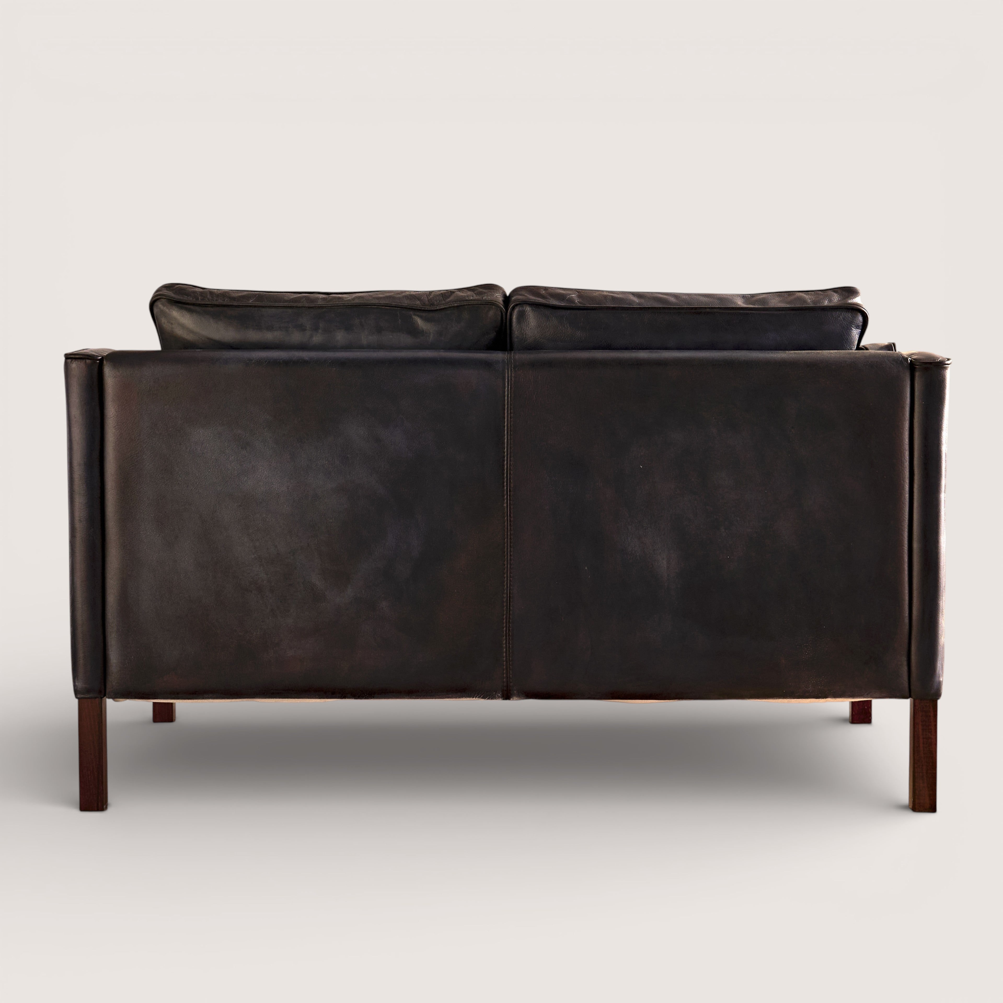 luxury-hand-dyed-mid-century-black-leather-two-seater-sofa-white-background-back