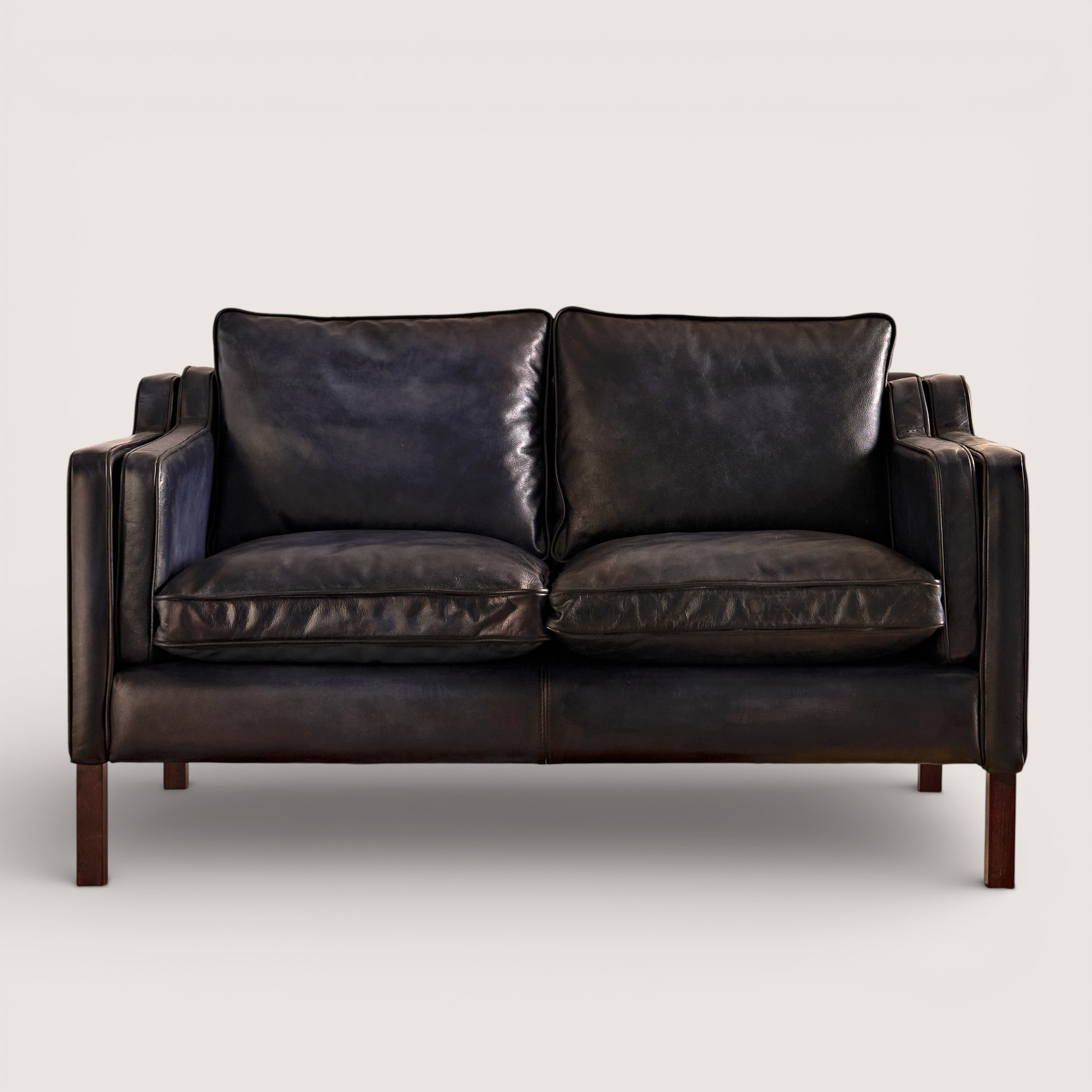 luxury-hand-dyed-mid-century-black-leather-two-seater-sofa-white-background-front
