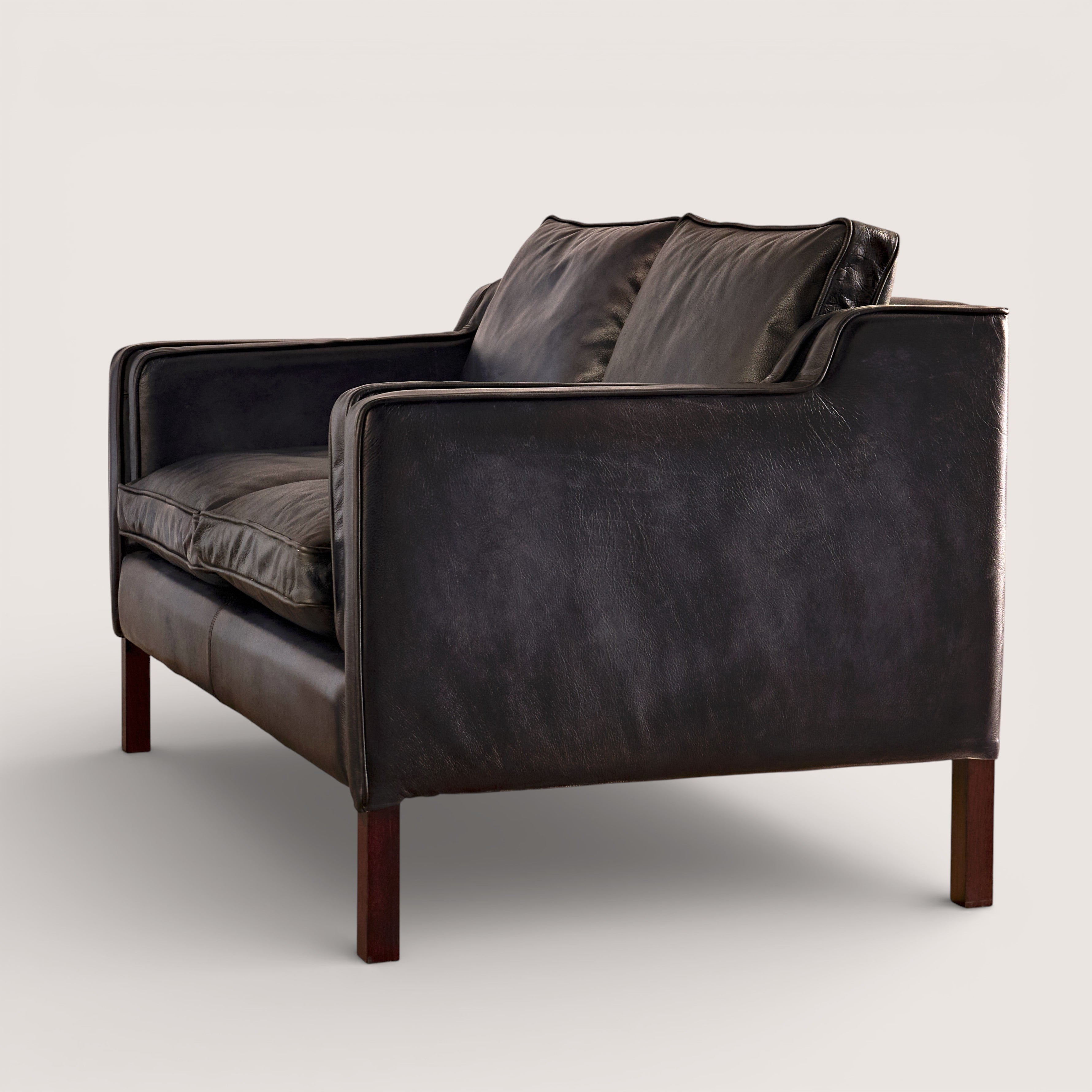 luxury-hand-dyed-mid-century-black-leather-two-seater-sofa-white-background-side