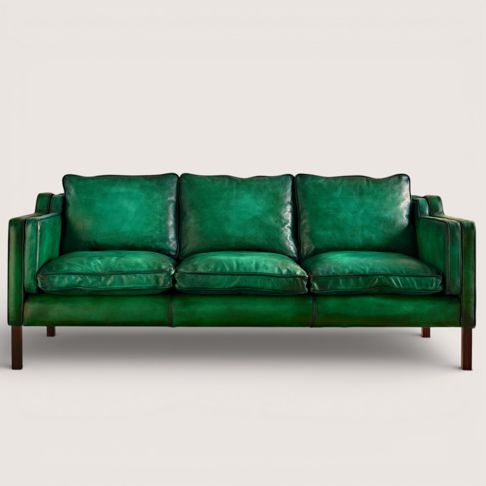 luxury-hand-dyed-mid-century-green-leather-three-seater-sofa-white-background-front