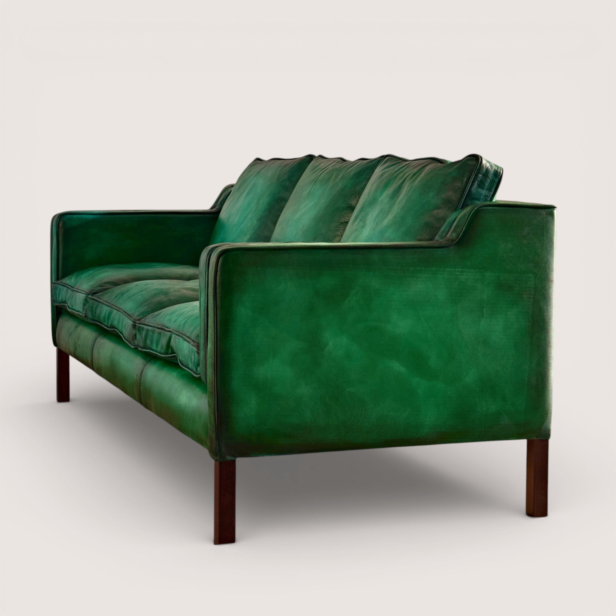 luxury-hand-dyed-mid-century-green-leather-three-seater-sofa-white-background-side