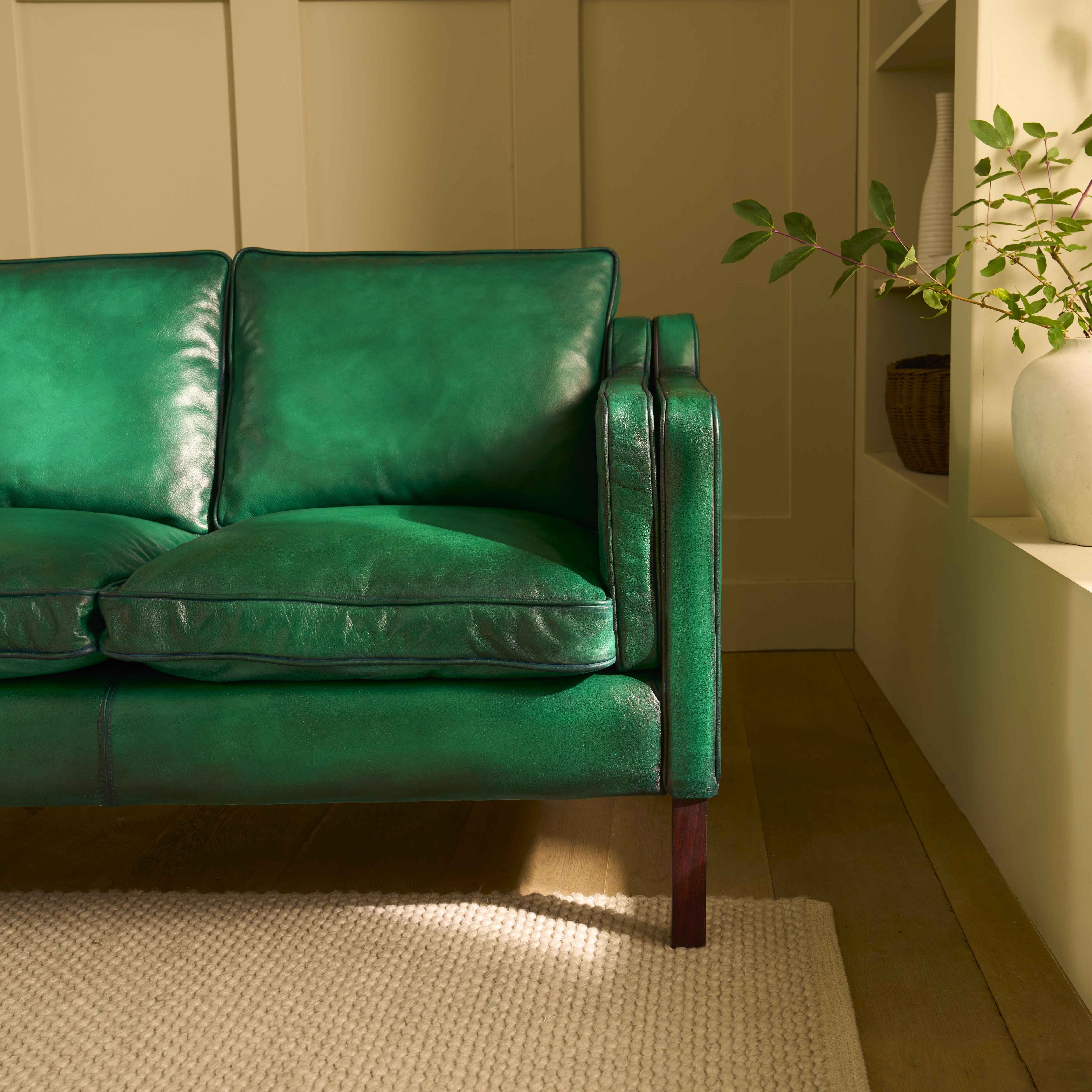 luxury-hand-dyed-mid-century-green-leather-two-seater-sofa-cottage-front-close