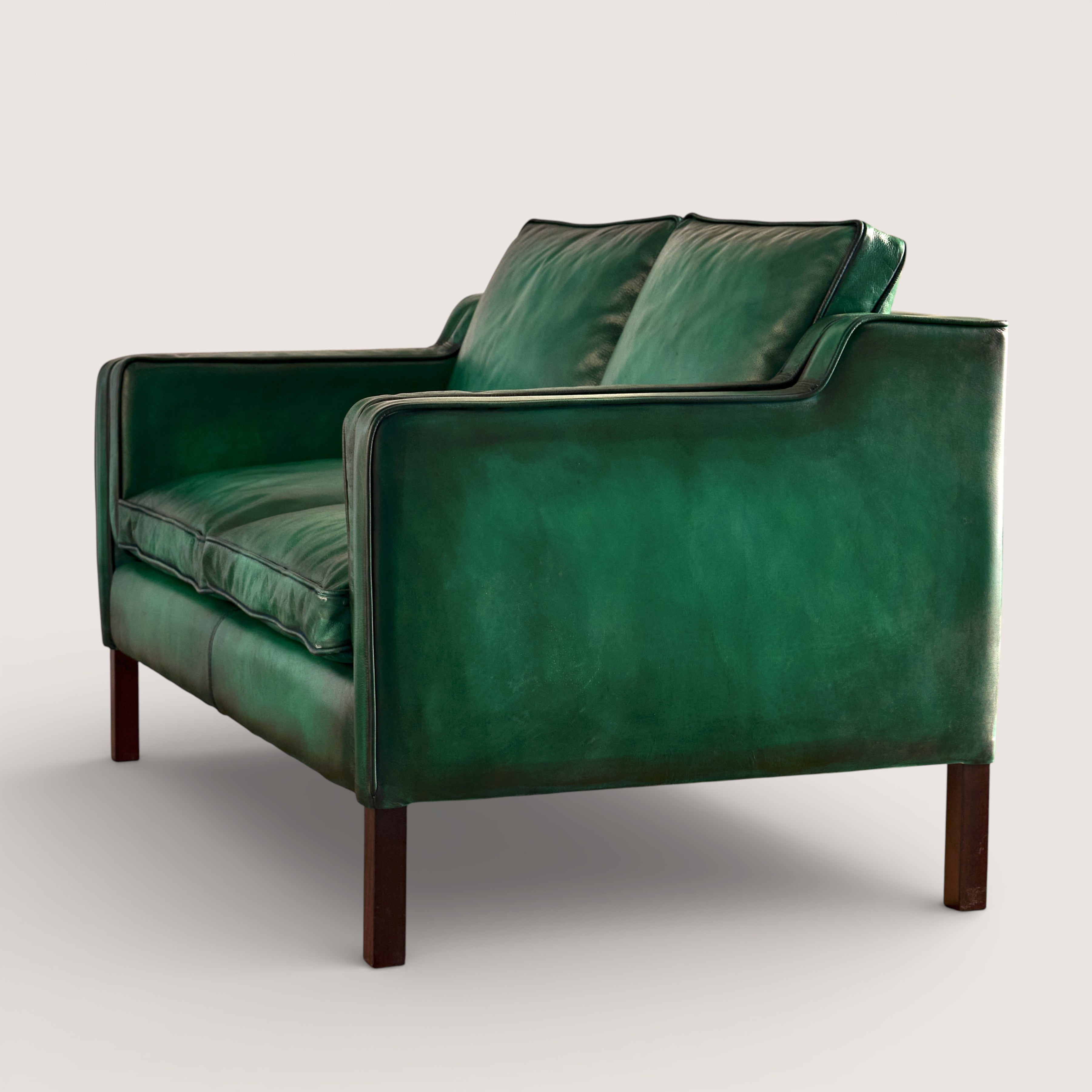 luxury-hand-dyed-mid-century-green-leather-two-seater-sofa-white-background-side