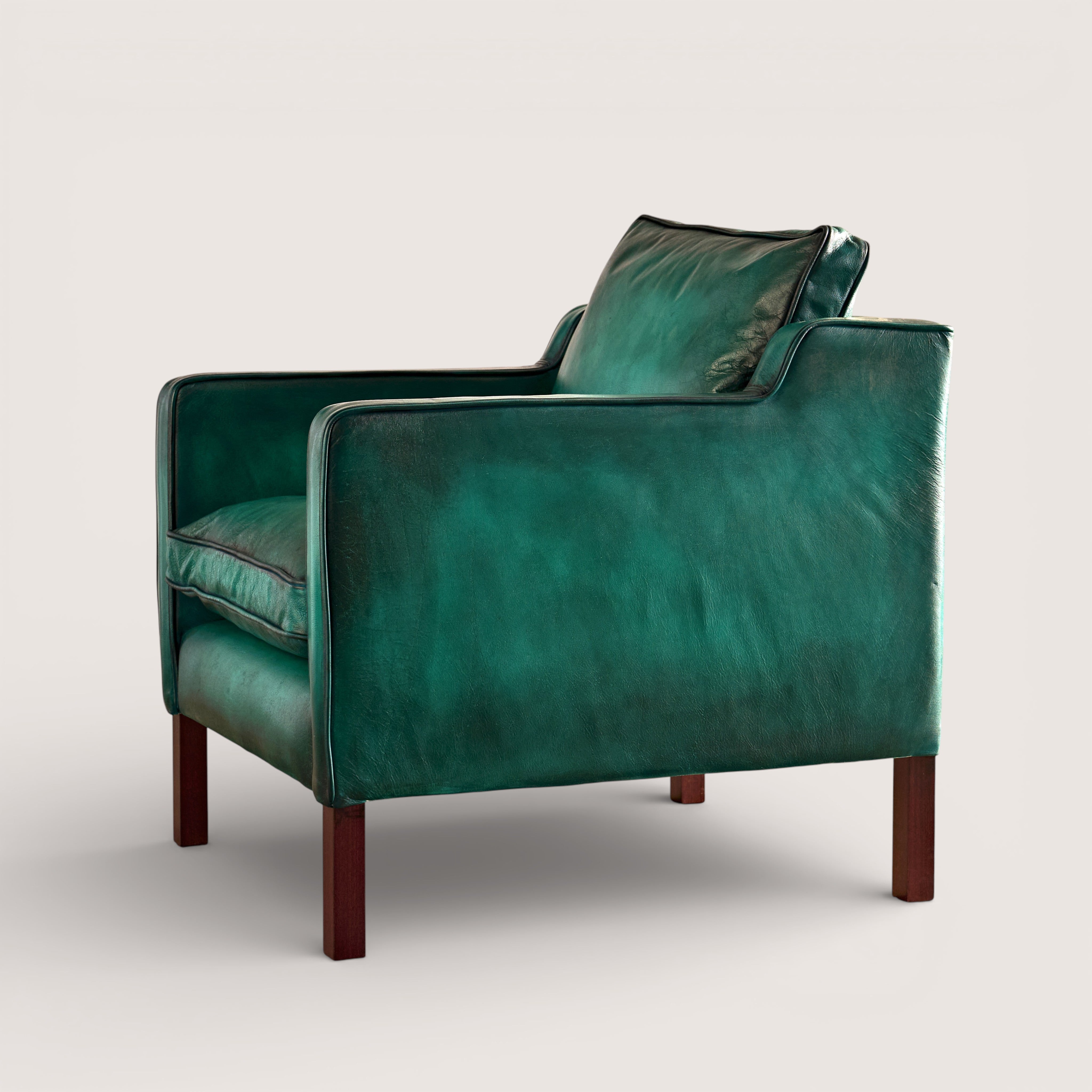 luxury-hand-dyed-mid-century-leather-armchair-white-background-side