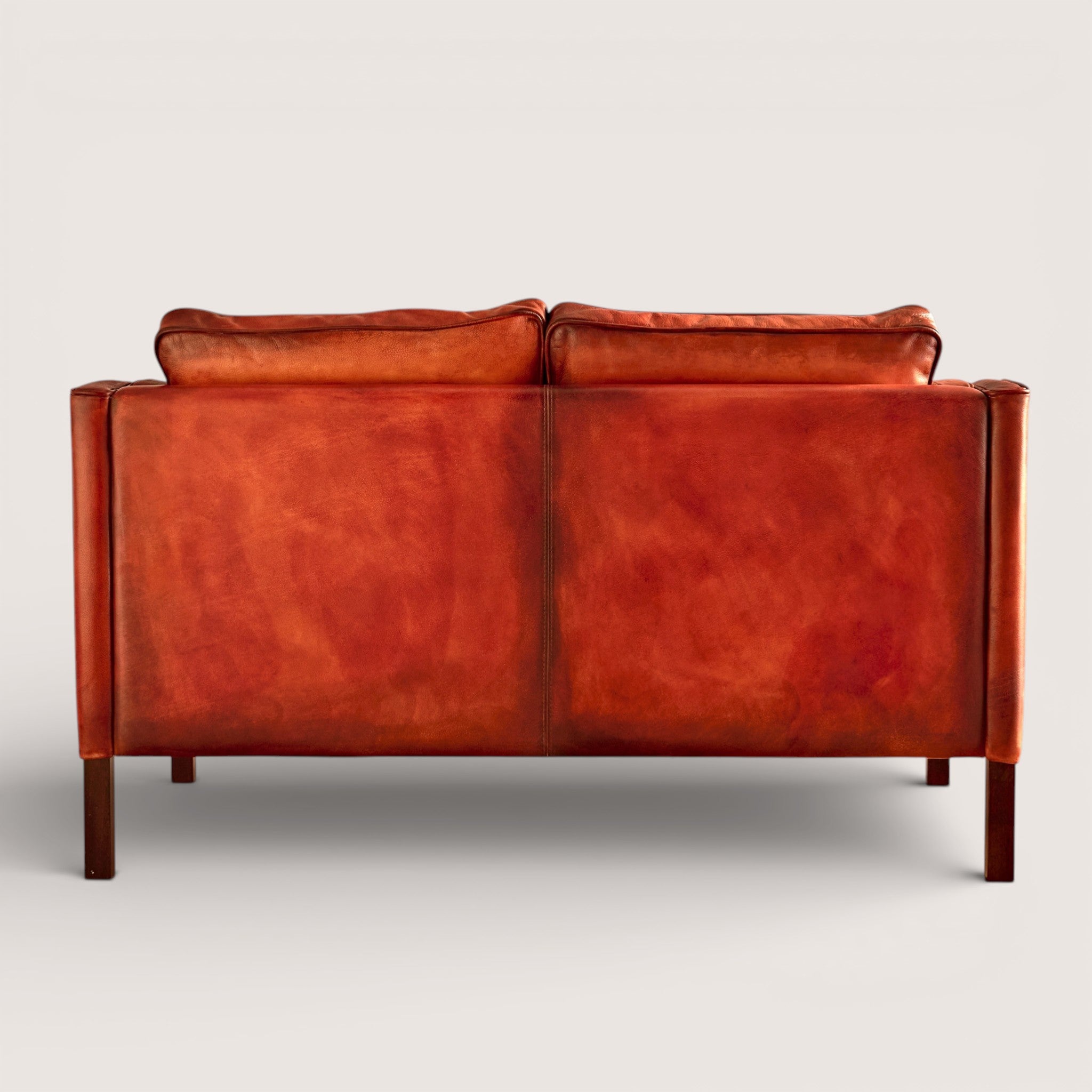 luxury-hand-dyed-mid-century-leather-two-seater-sofa-white-background-back