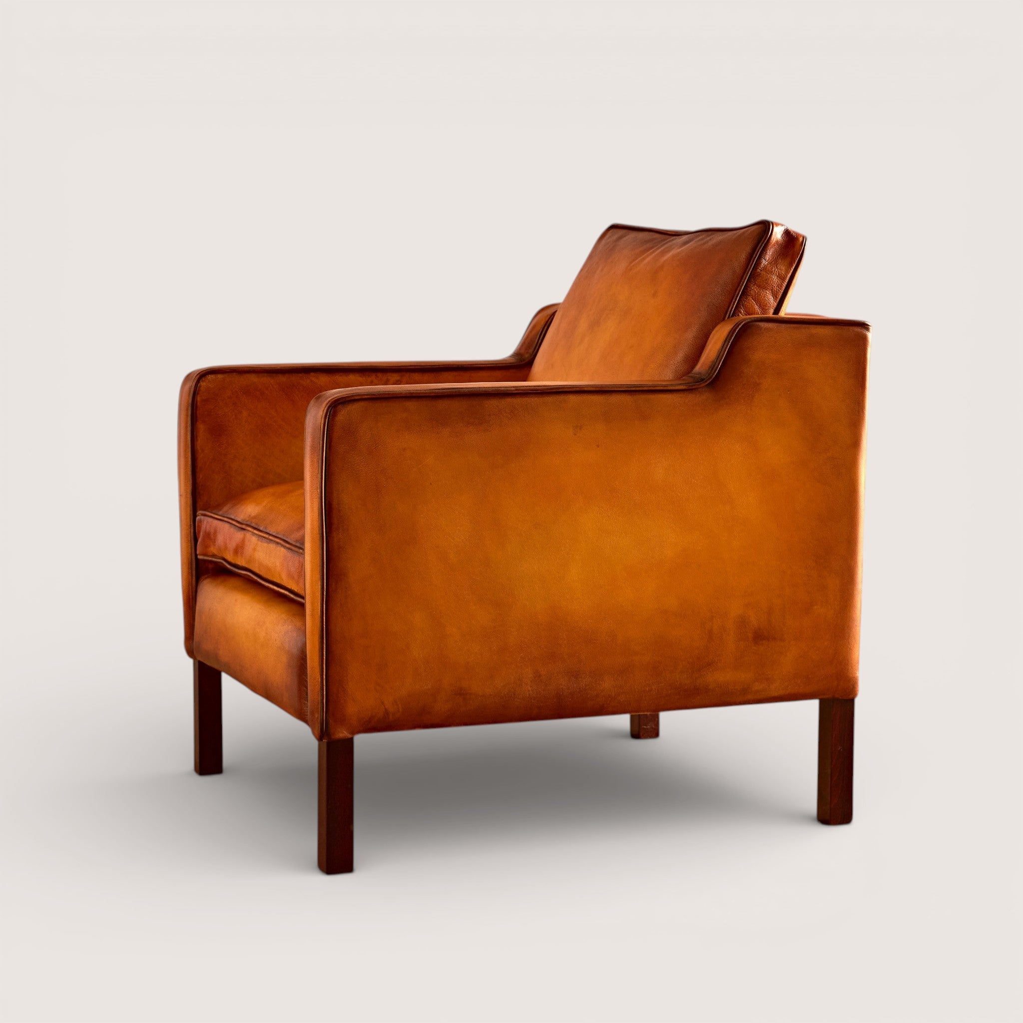 luxury-hand-dyed-mid-century-tan-leather-armchair-white-background-side