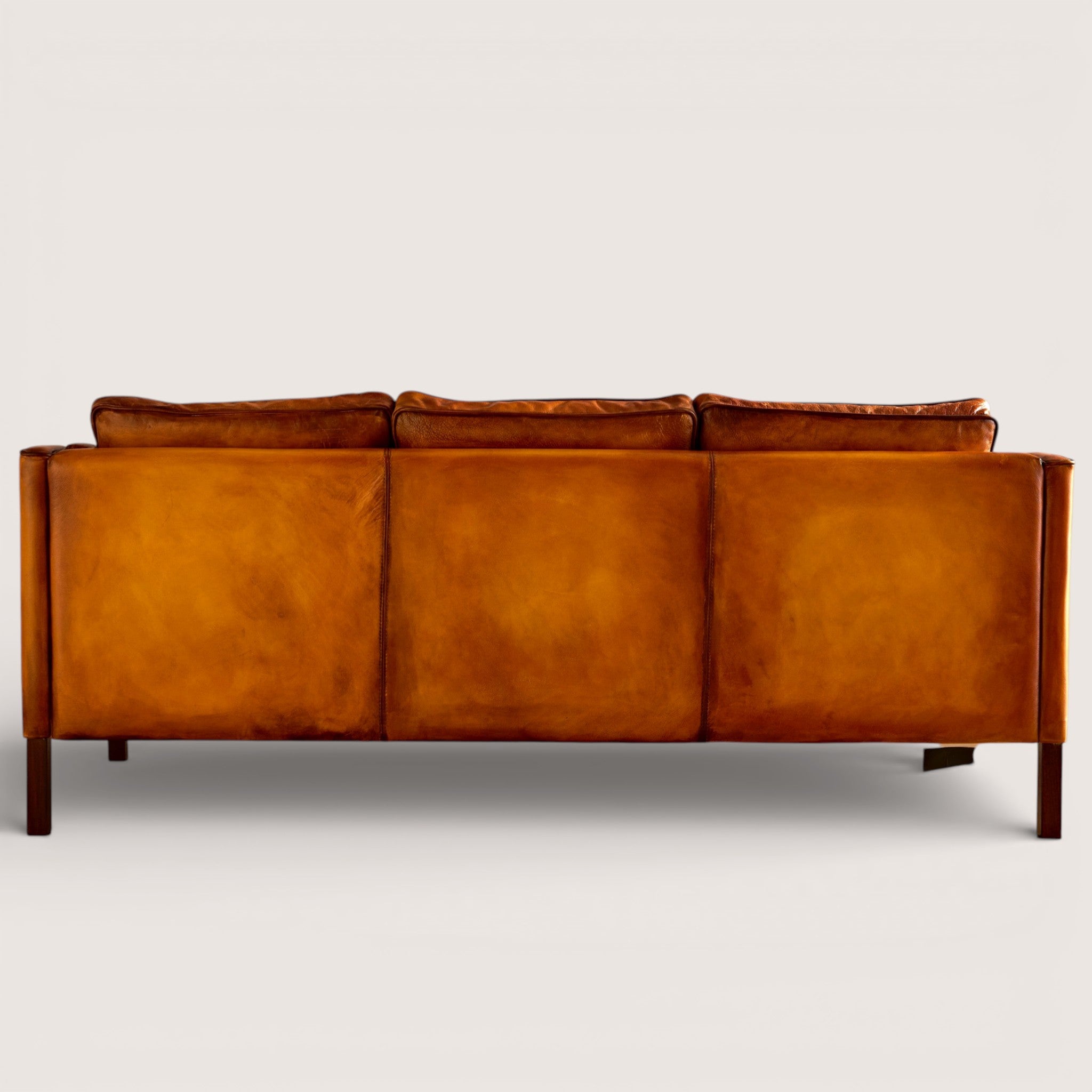 luxury-hand-dyed-mid-century-tan-leather-three-seater-sofa-white-background-back
