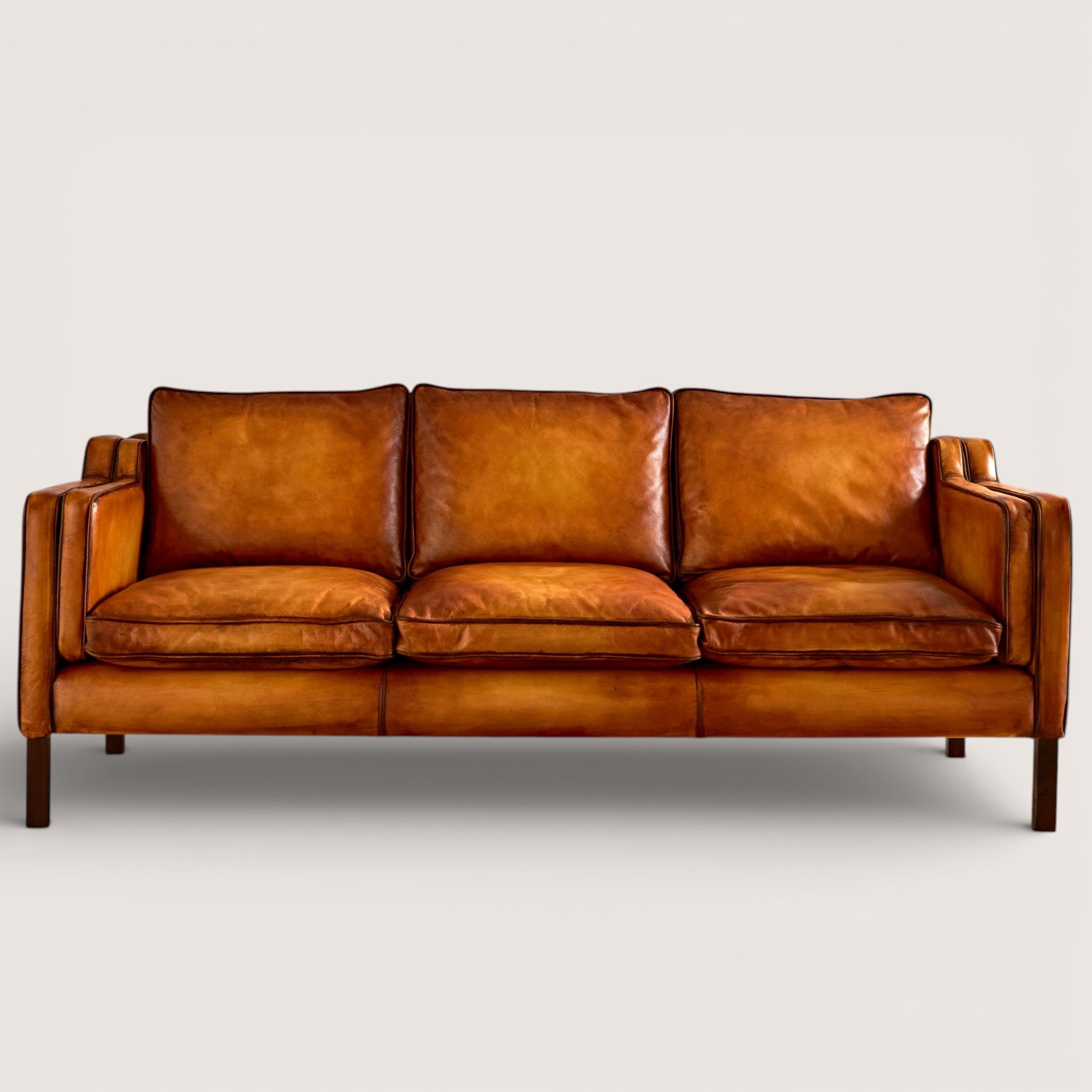 luxury-hand-dyed-mid-century-tan-leather-three-seater-sofa-white-background-back