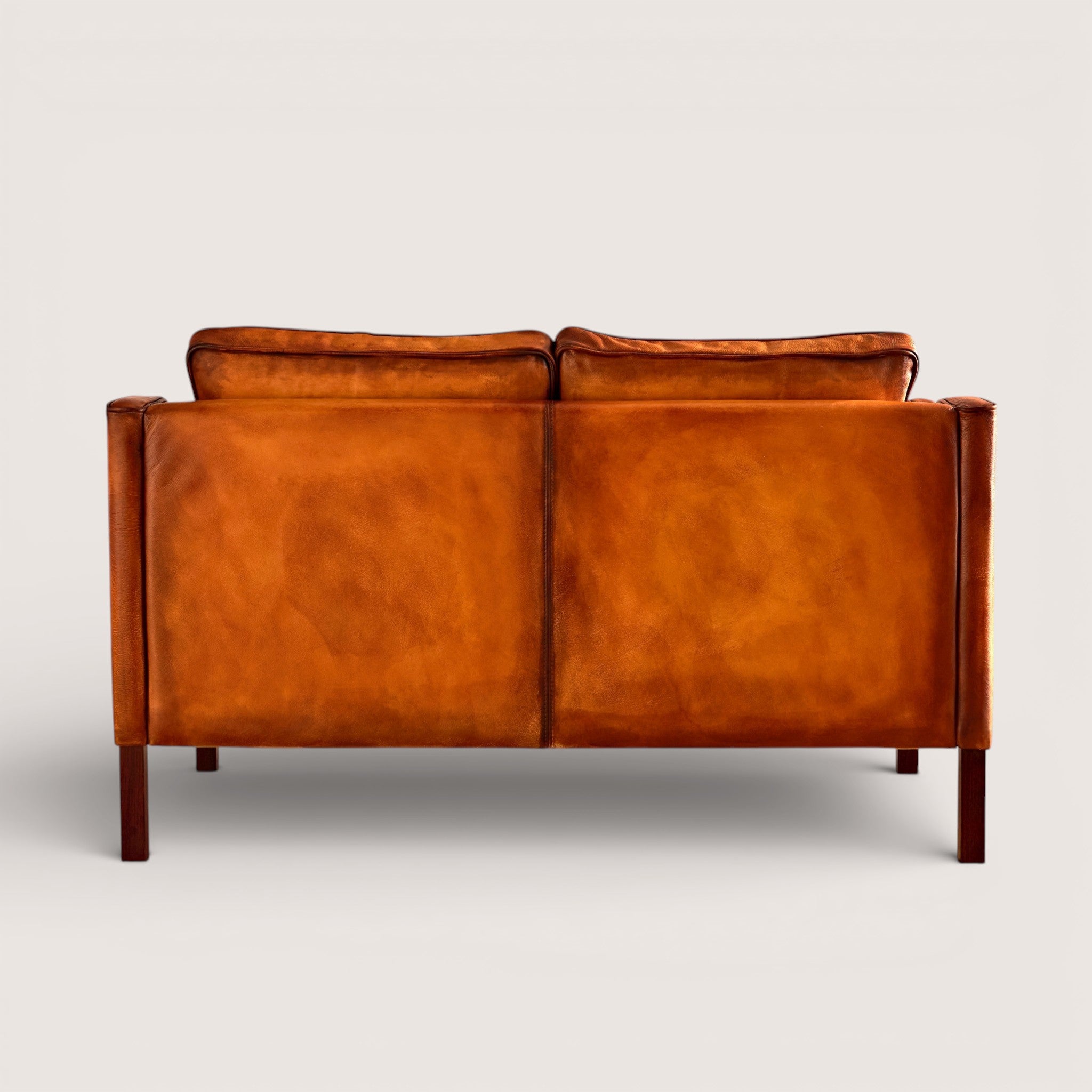 luxury-hand-dyed-mid-century-tan-leather-two-seater-sofa-white-background-back
